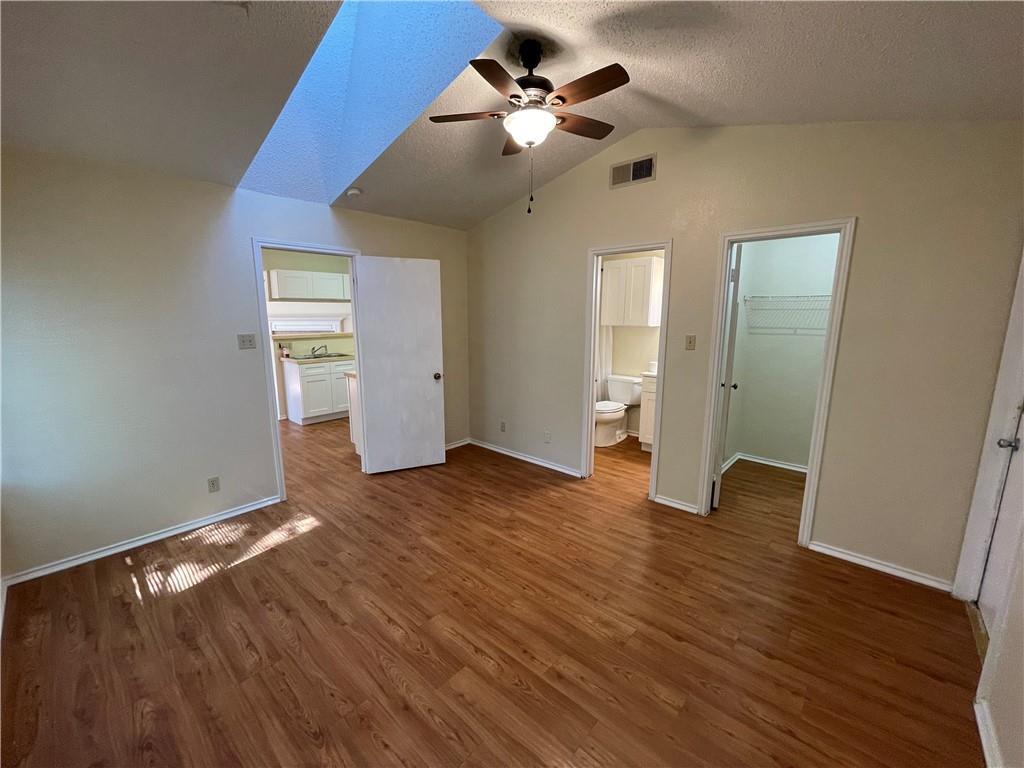 10003 Parliament House Road Austin, TX 78717 - Photo 21 of 31 a view of an empty room with wooden floor and a ceiling fan