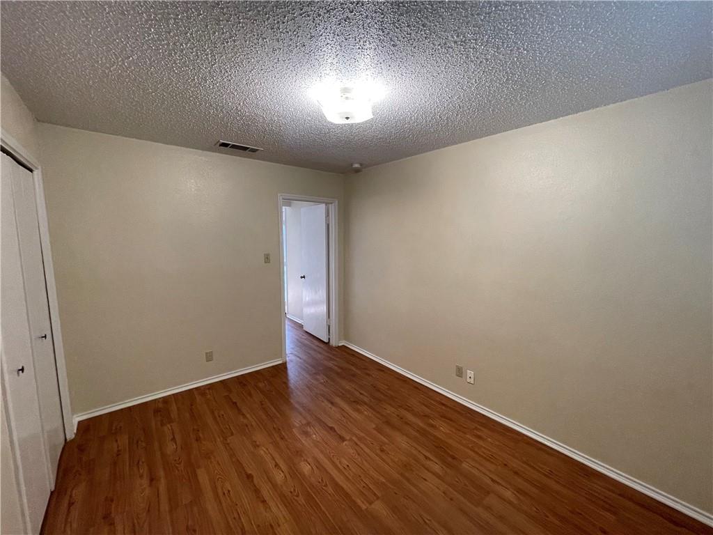 10003 Parliament House Road Austin, TX 78717 - Photo 25 of 31 a view of an empty room with wooden floor