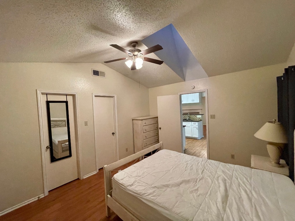 10003 Parliament House Road Austin, TX 78717 - Photo 5 of 31 a bedroom with a bed and a chandelier