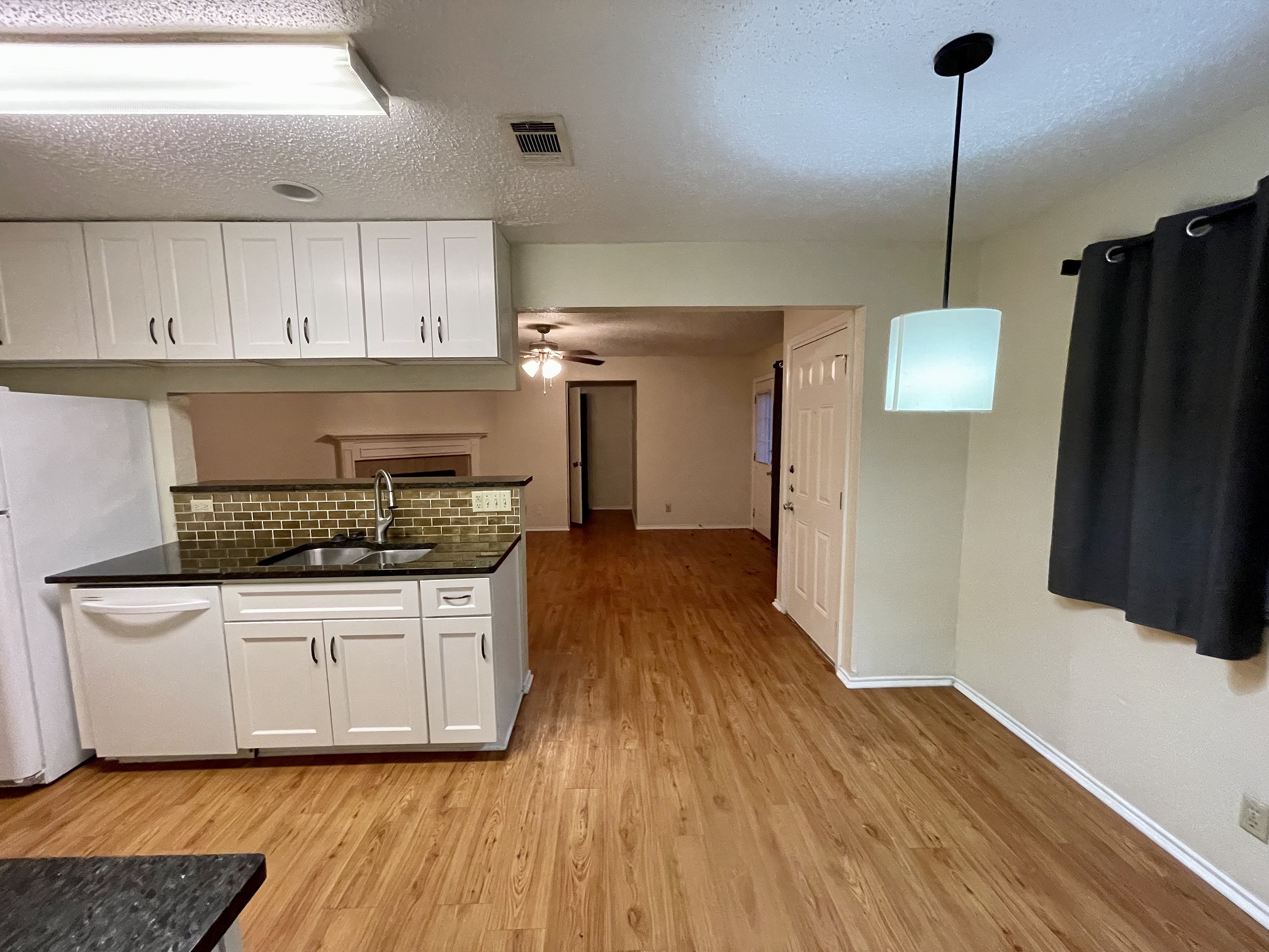 10003 Parliament House Road Austin, TX 78717 - Photo 29 of 31 a kitchen with a stove a refrigerator and a wooden floor