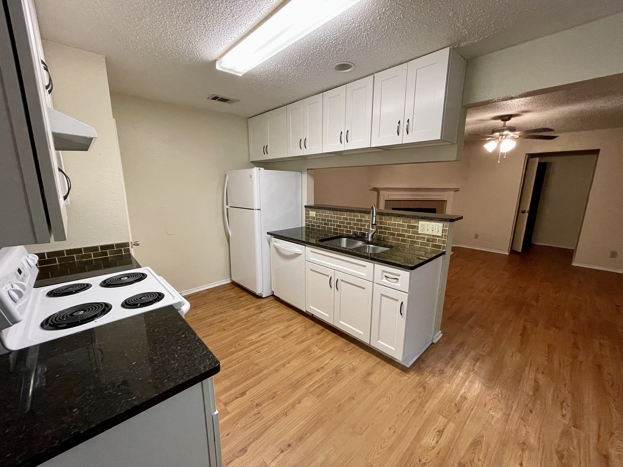 10003 Parliament House Road Austin, TX 78717 - Photo 6 of 31 a kitchen with granite countertop a stove and a sink