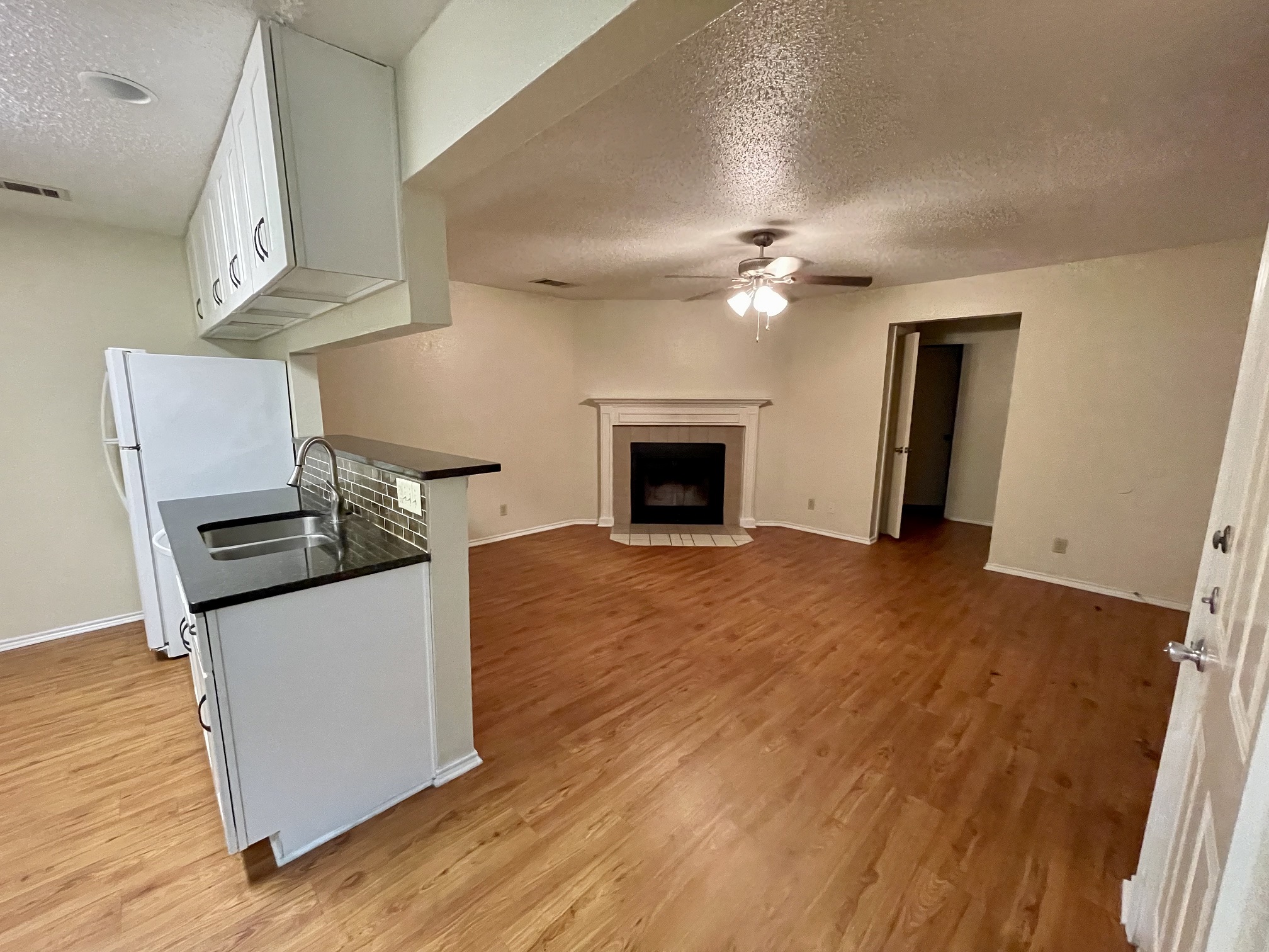 10003 Parliament House Road Austin, TX 78717 - Photo 30 of 31 a view of a kitchen with wooden floor and a fireplace