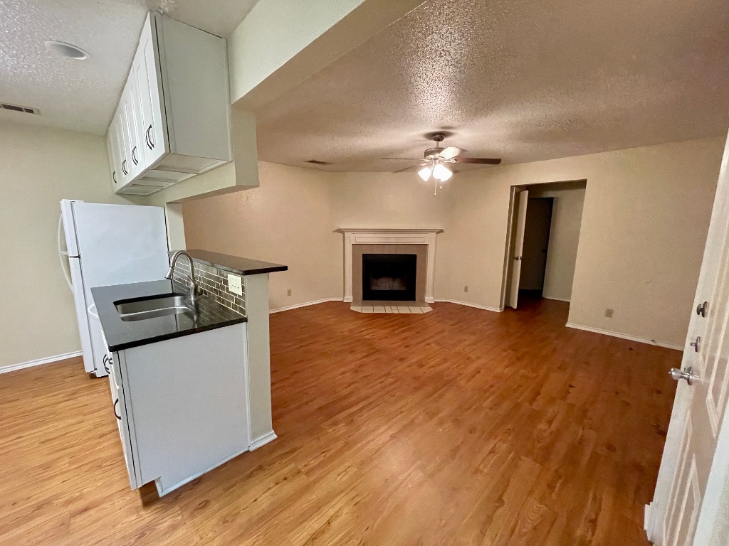 10003 Parliament House Road Austin, TX 78717 - Photo 30 of 31 a view of a kitchen with wooden floor and a fireplace