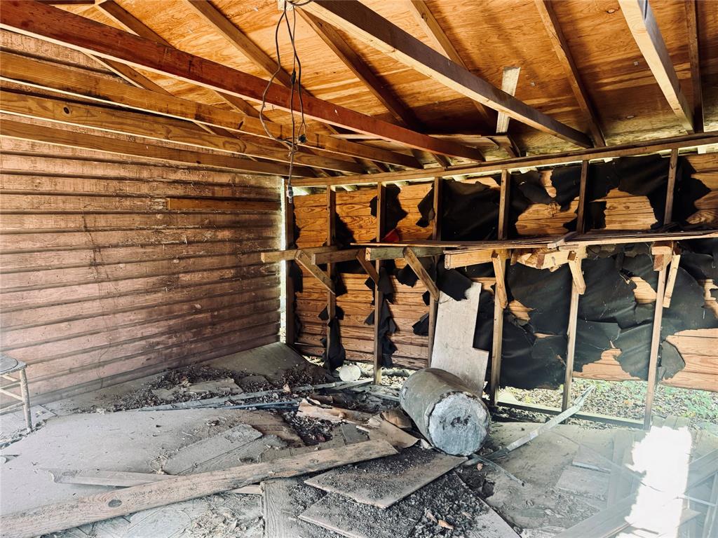 2250 West Kaufman Street Paris, TX 75460 - Photo 31 of 36 a room with water heater and wooden walls