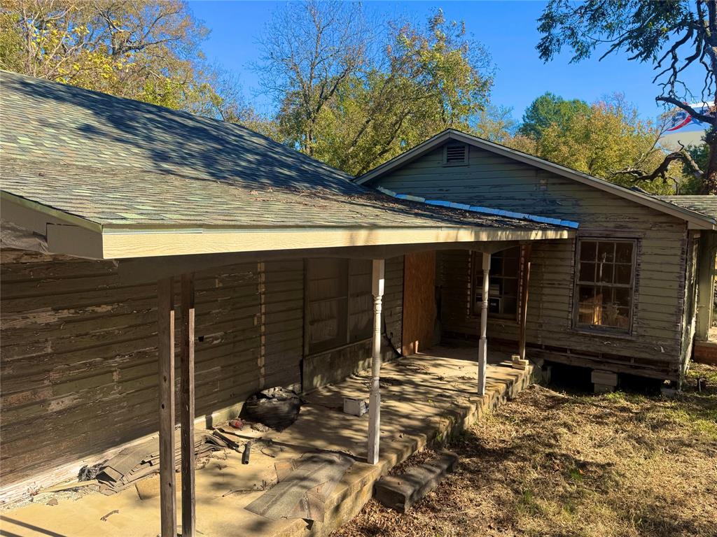 2250 West Kaufman Street Paris, TX 75460 - Photo 5 of 36 a view of house with wooden fence in front of it