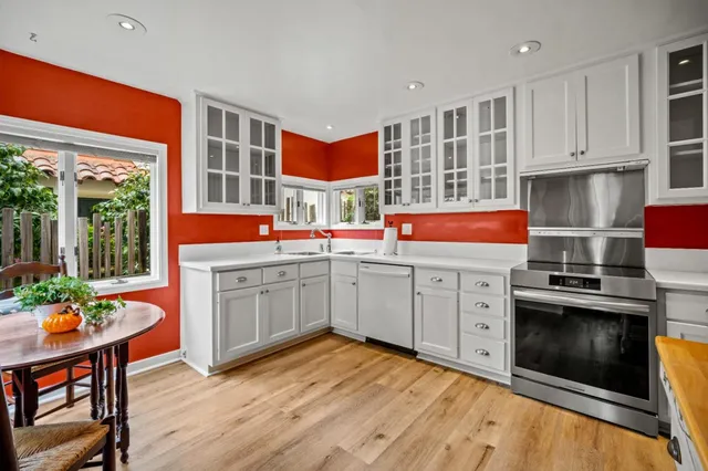 a open kitchen with stainless steel appliances granite countertop a stove and cabinets