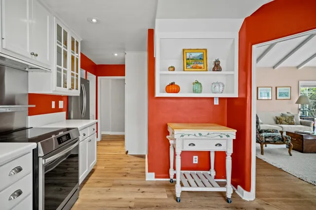 an empty room with wooden floor furniture and windows