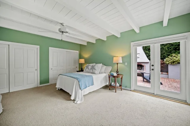 a spacious bedroom with a bed and a chandelier