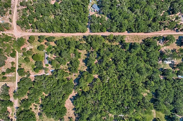 a backyard of a house with lots of green space and trees