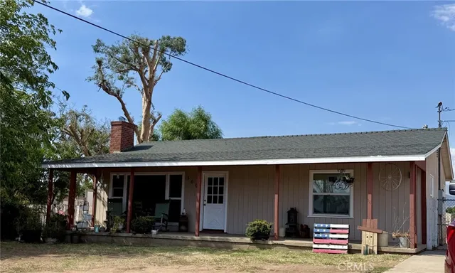 a view of a house with small yard plants and furniture