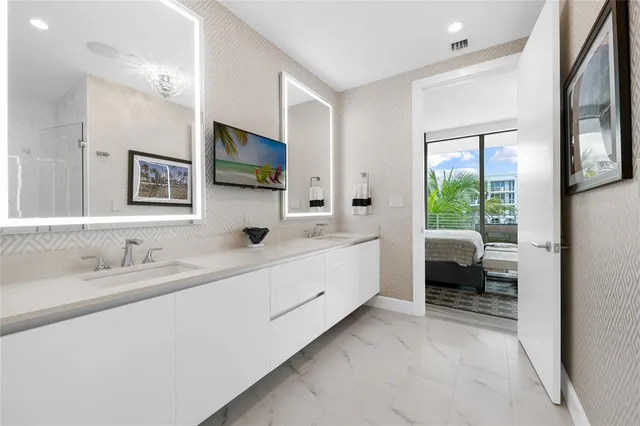 a white toilet sitting next to a bathroom sink