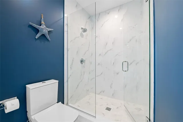 a view of a balcony with wooden floor and outdoor seating