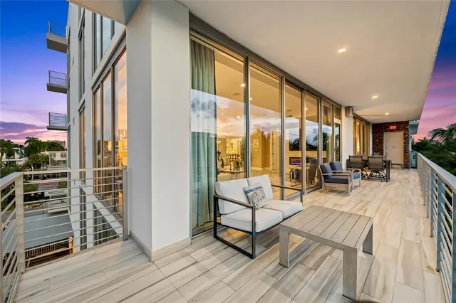 a view of a hallway with wooden floor and a potted plant