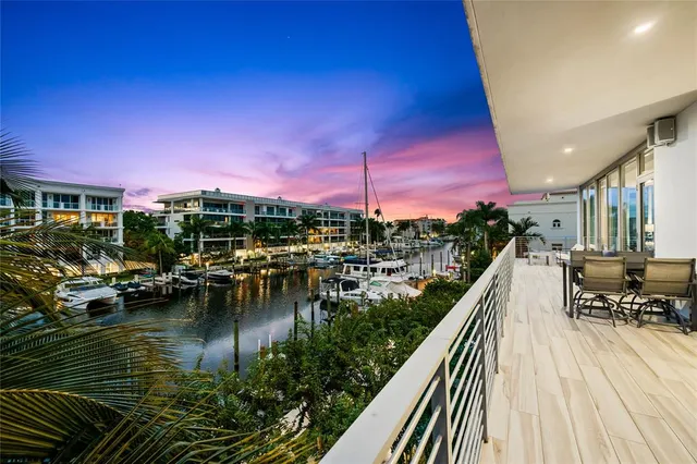 a living room with furniture a floor to ceiling window and a flat screen tv