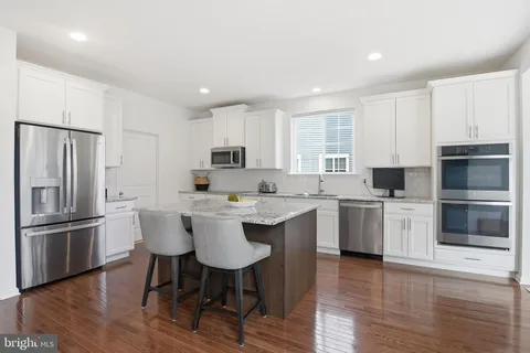 a kitchen with a sink stainless steel appliances and cabinets