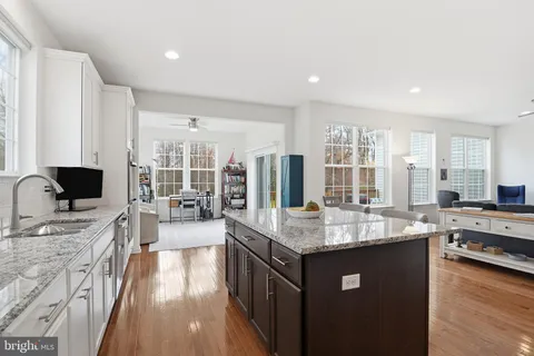 a open kitchen with stainless steel appliances granite countertop a sink stove and refrigerator