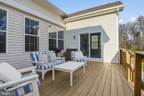 a view of a chair and table on the deck