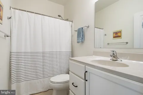 a bathroom with a sink toilet and mirror