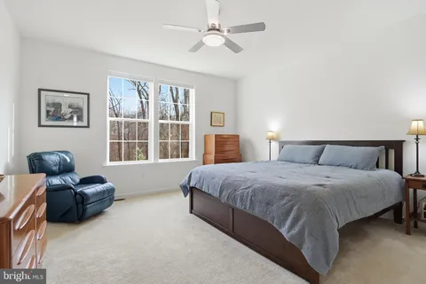 a spacious bedroom with a bed and furniture