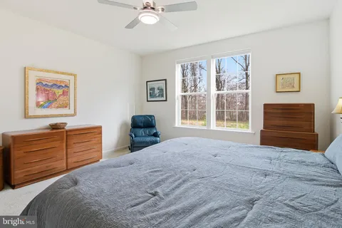a bedroom with a bed cabinets and window