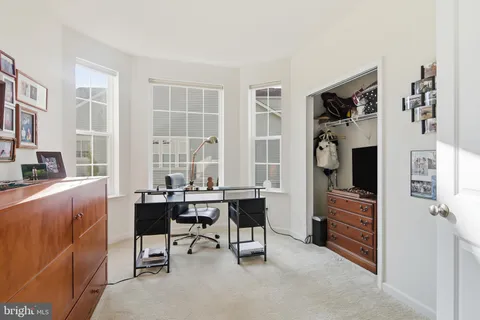 a room with furniture a rug and a window