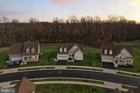an aerial view of residential houses with outdoor space and swimming pool