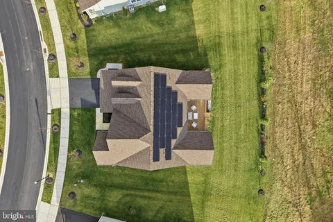 a front view of a house with a yard and trees
