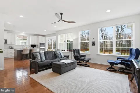 a living room with furniture gym equipment and view of kitchen