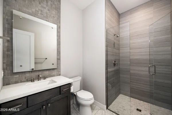 a bathroom with a sink shower and a toilet