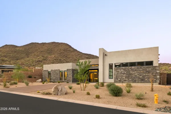 an aerial view of a house with yard garage and outdoor seating