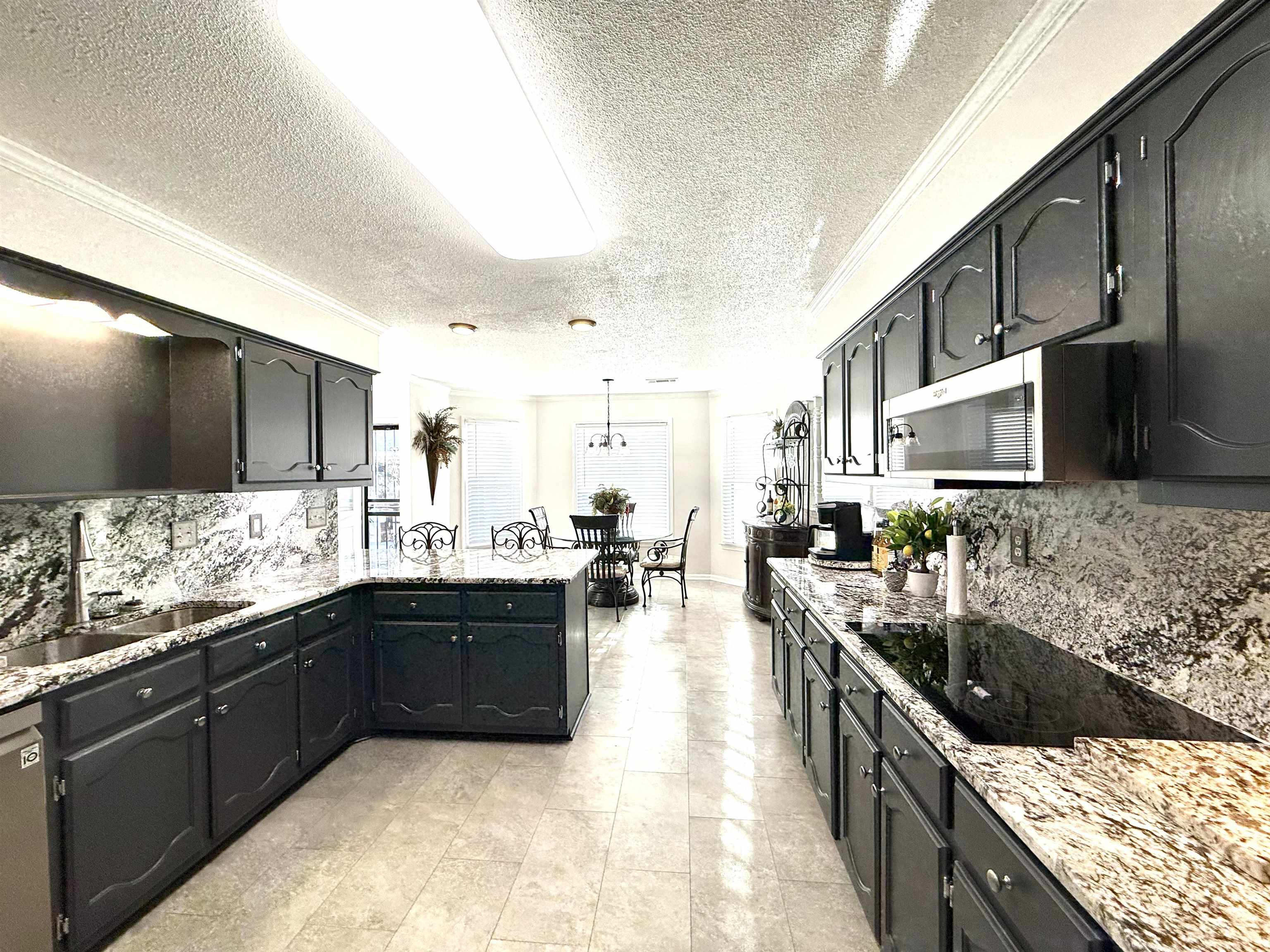 825 North Walnut Bend Road Memphis, TN 38018 - Photo 13 of 40 a kitchen with stainless steel appliances granite countertop a sink a stove and a wooden floors