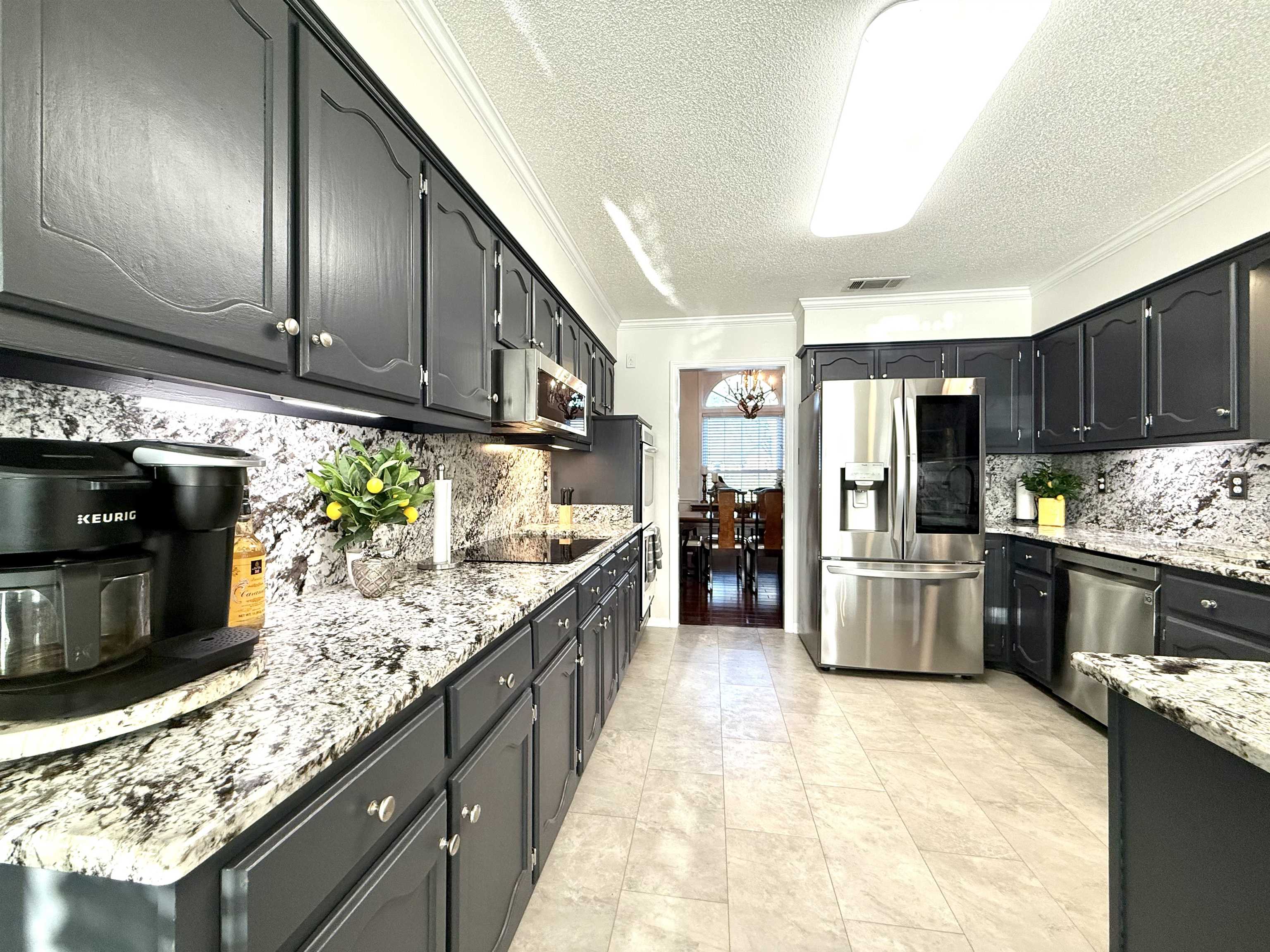 825 North Walnut Bend Road Memphis, TN 38018 - Photo 14 of 40 a large kitchen with granite countertop stainless steel appliances and wooden cabinets