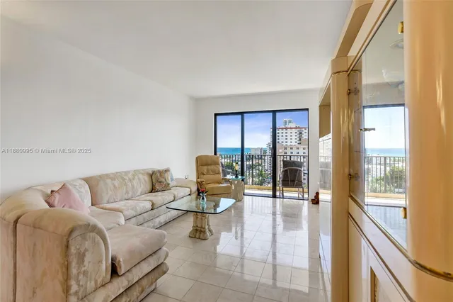 a living room with furniture and white kitchen