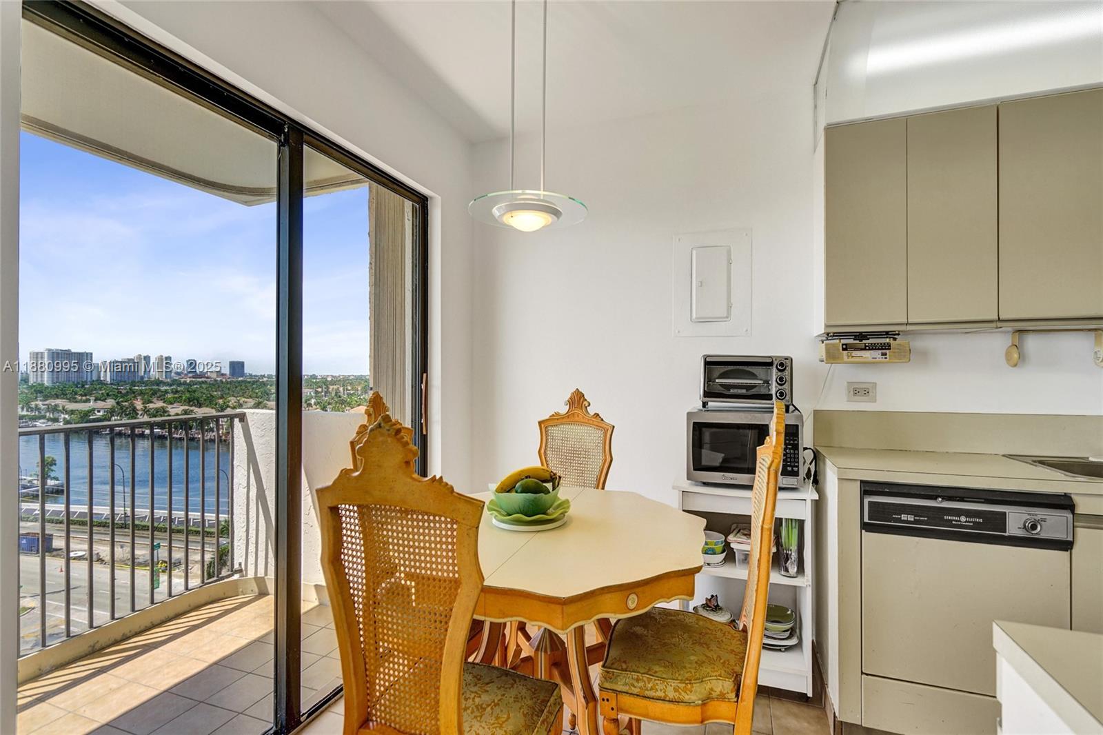 1201 South Ocean Drive, Unit 1010S Hollywood, FL 33019 - Photo 16 of 41 a kitchen with stainless steel appliances a stove a table and chairs