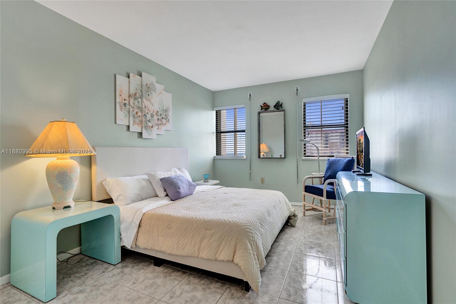 1201 South Ocean Drive, Unit 1010S Hollywood, FL 33019 - Photo 20 of 41 a bedroom with a bed and wooden floor