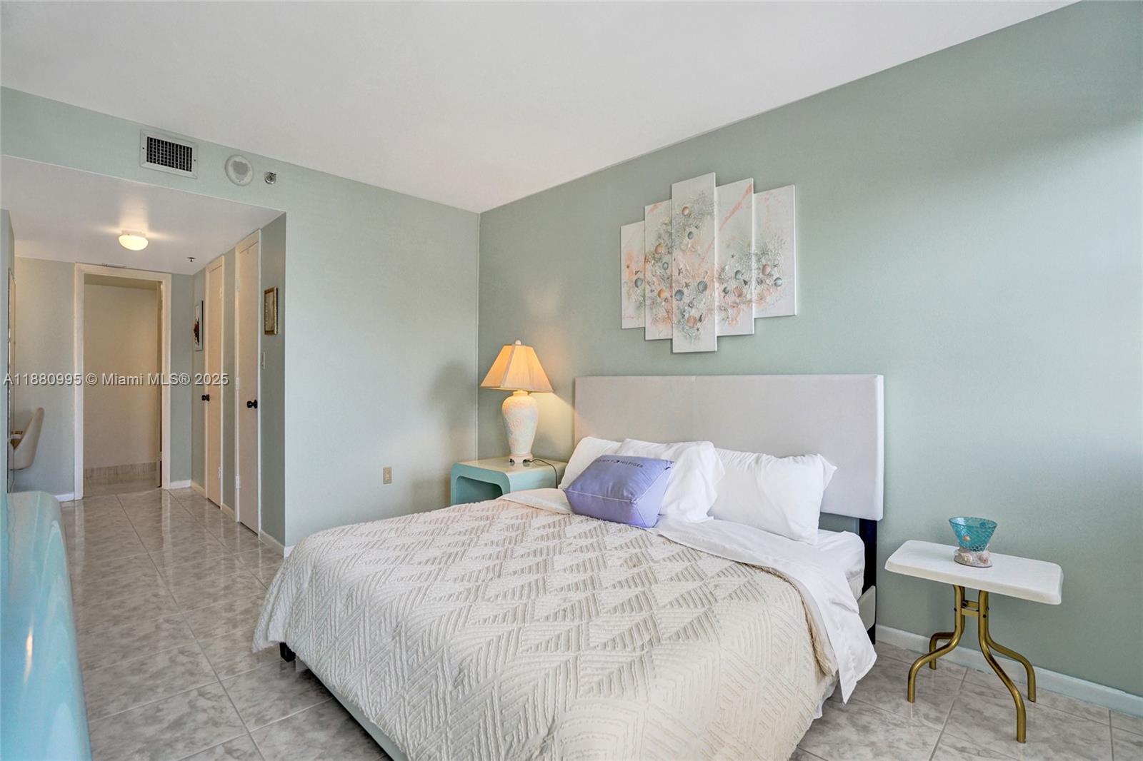 1201 South Ocean Drive, Unit 1010S Hollywood, FL 33019 - Photo 22 of 41 a bedroom with a bed and a painting on the wall