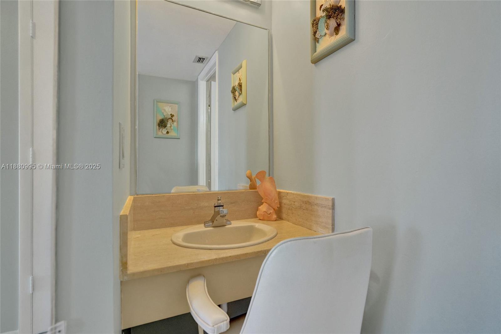 1201 South Ocean Drive, Unit 1010S Hollywood, FL 33019 - Photo 25 of 41 a bathroom with a sink and mirror with toilet