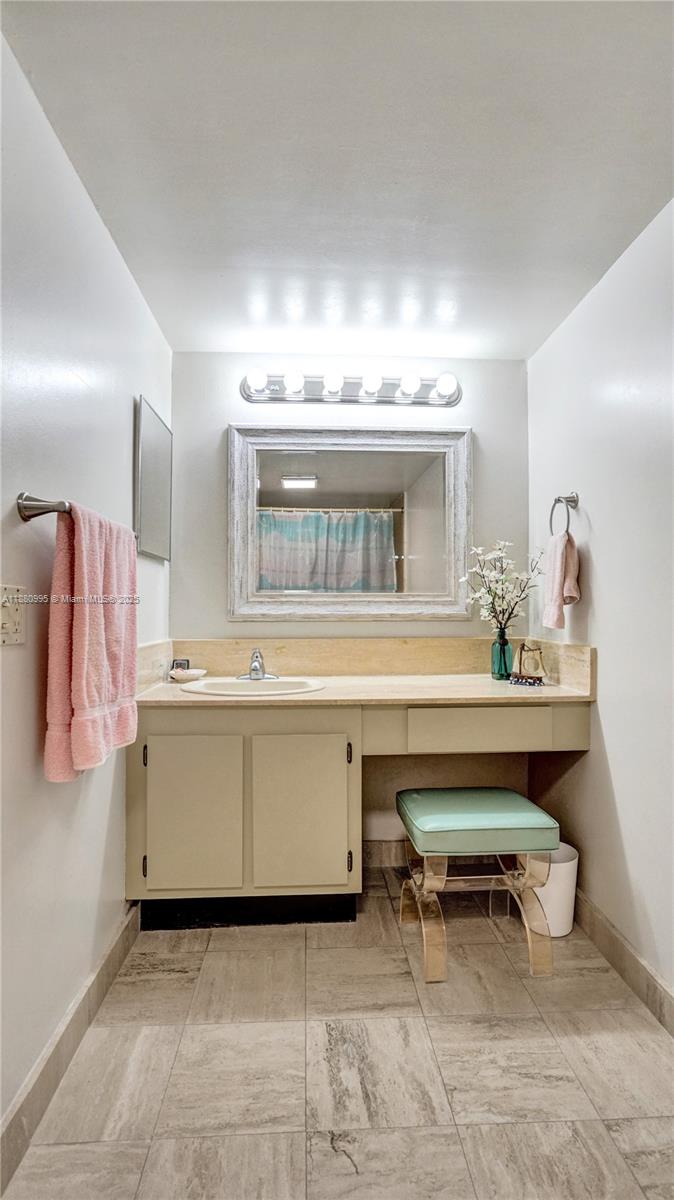 1201 South Ocean Drive, Unit 1010S Hollywood, FL 33019 - Photo 26 of 41 a room with a sink and a mirror