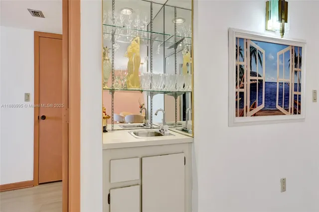 a view of a hallway with wooden floor and dining room