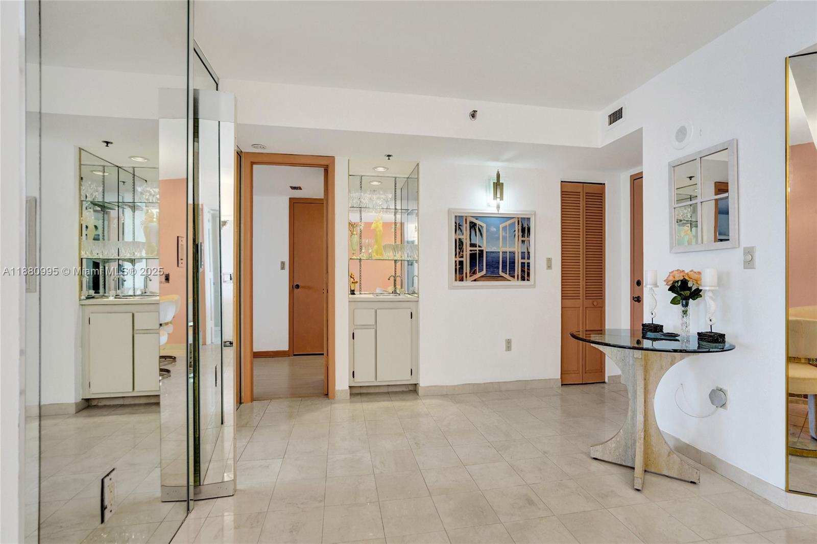1201 South Ocean Drive, Unit 1010S Hollywood, FL 33019 - Photo 9 of 41 a view of a hallway with wooden floor and dining room