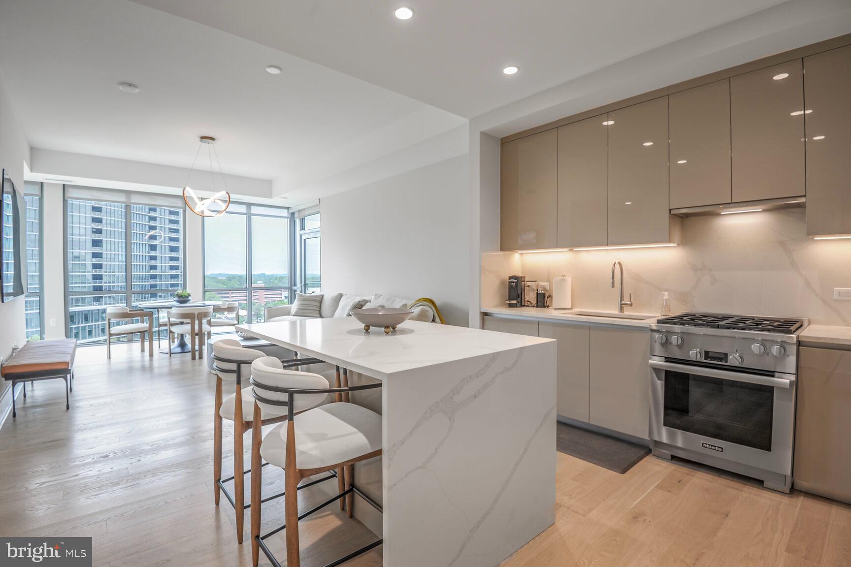7887 Jones Branch Drive, Unit 803 McLean, VA 22102 - Photo 35 of 35 a kitchen with a table chairs stove and cabinets