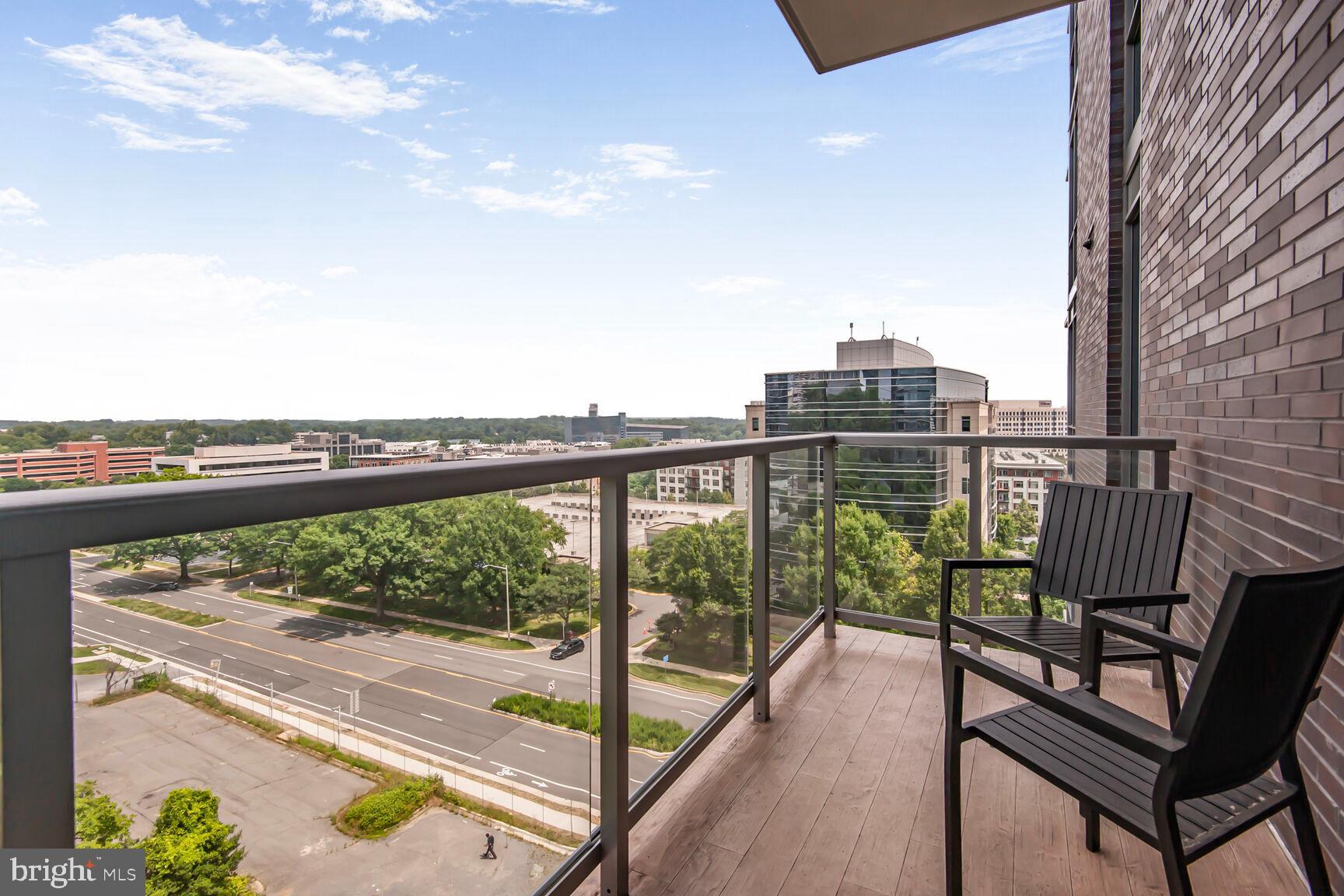 7887 Jones Branch Drive, Unit 803 McLean, VA 22102 - Photo 10 of 35 a view of a balcony with wooden floor and outdoor seating