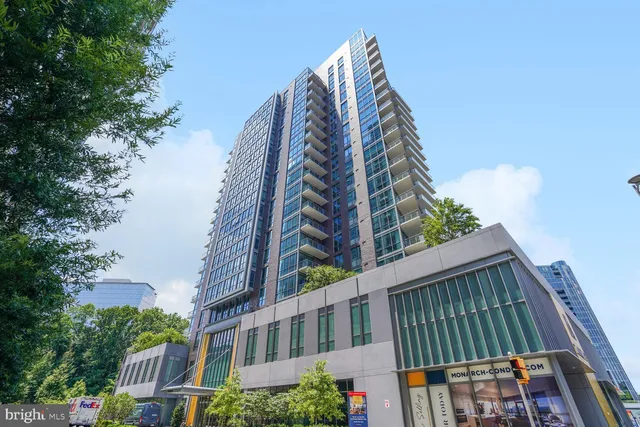 a view of a balcony with wooden floor and outdoor seating