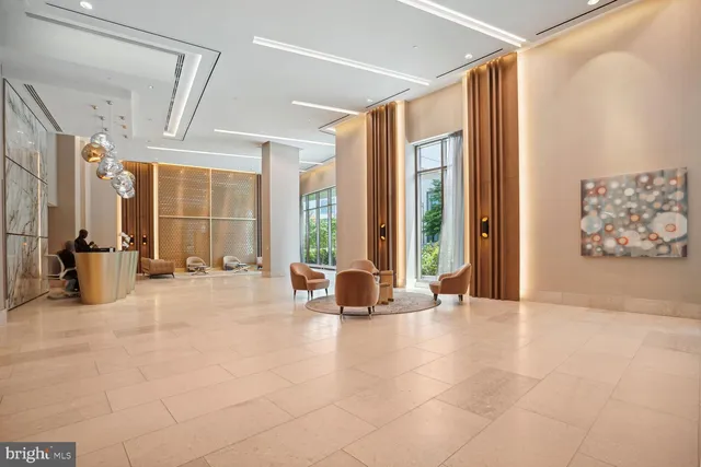 a living room with furniture and large windows