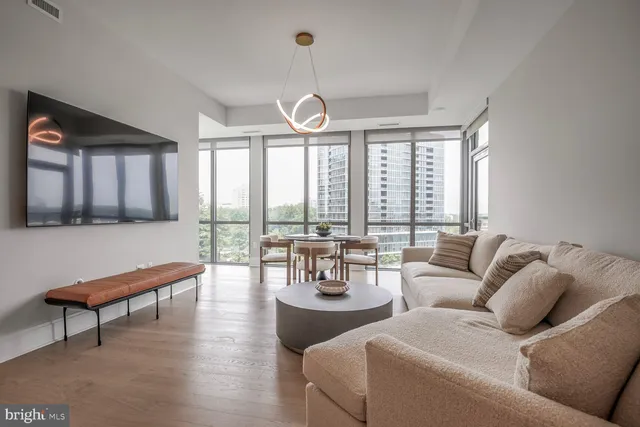 a kitchen with a table chairs stove and cabinets