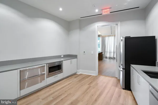a kitchen with stainless steel appliances a stove a refrigerator and a sink