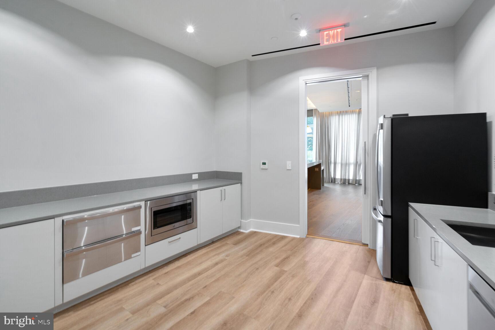 7887 Jones Branch Drive, Unit 803 McLean, VA 22102 - Photo 21 of 35 a kitchen with stainless steel appliances a stove a refrigerator and a sink