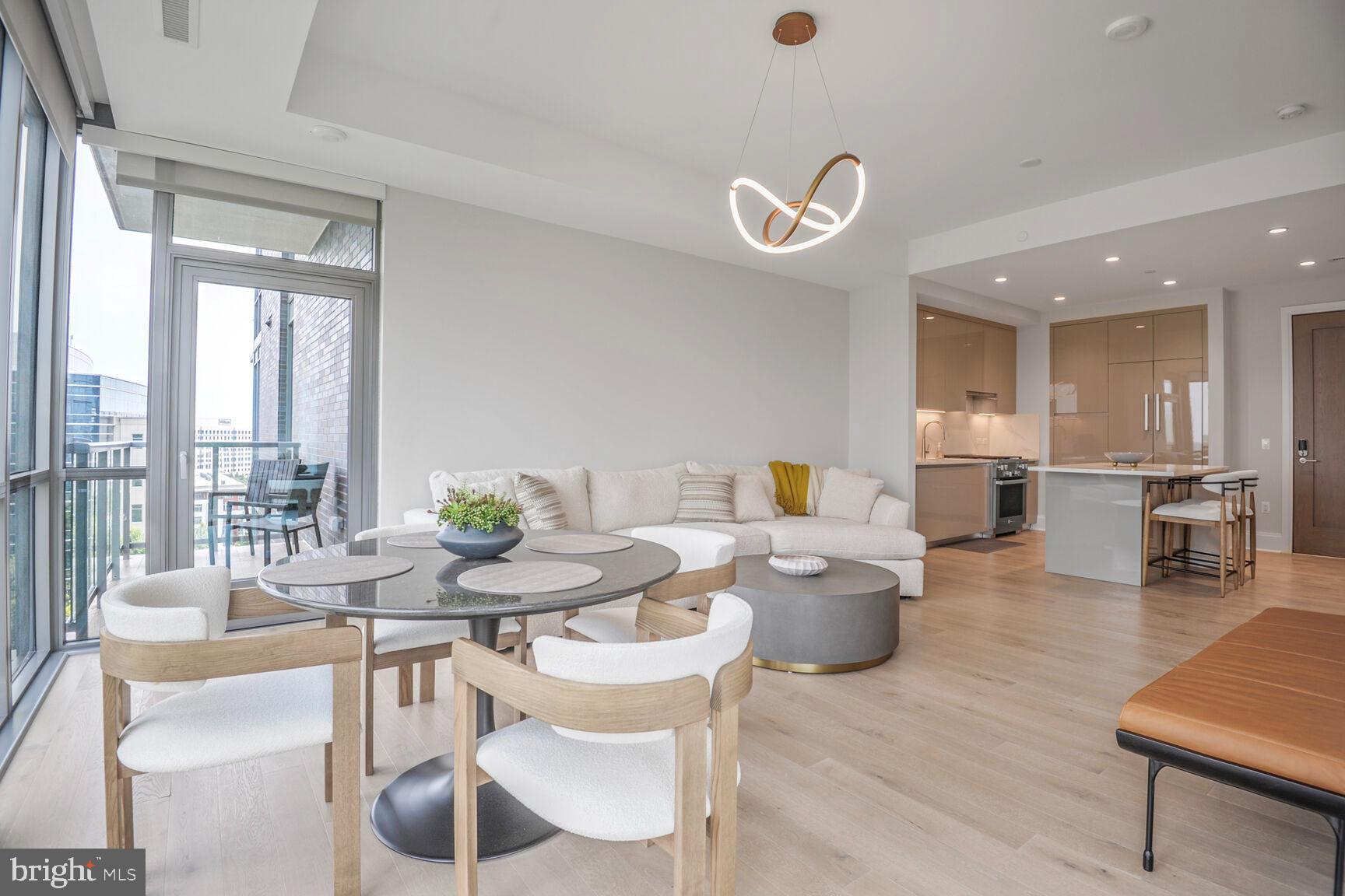 7887 Jones Branch Drive, Unit 803 McLean, VA 22102 - Photo 2 of 35 a dining room with wooden floor and large windows