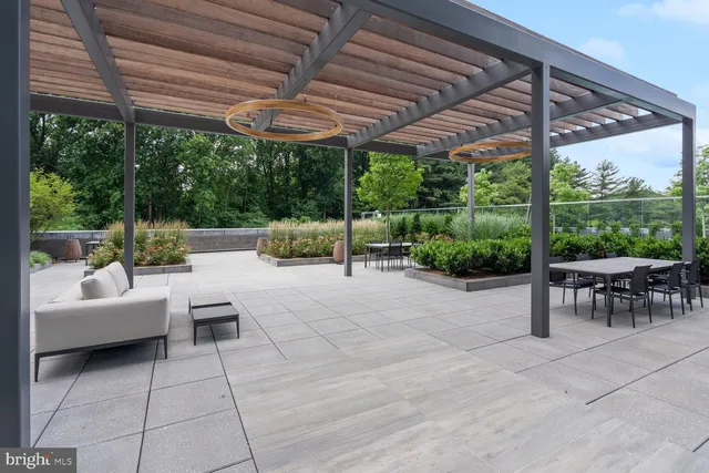 a view of patio with a table and chairs under an umbrella