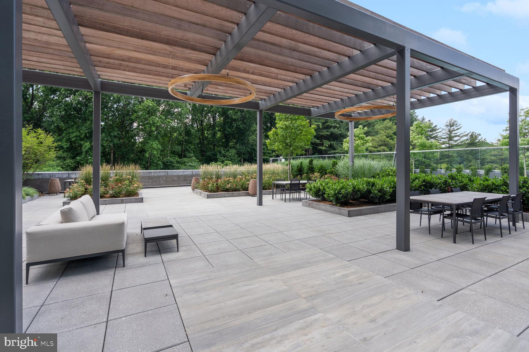7887 Jones Branch Drive, Unit 803 McLean, VA 22102 - Photo 31 of 35 a view of patio with a table and chairs under an umbrella